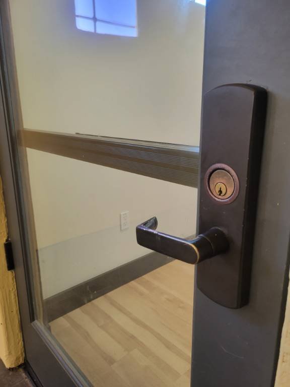 Commercial storefront mortise lock installed on a glass entry door