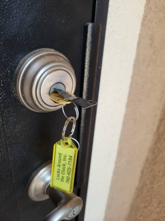 Freshly rekeyed residential deadbolt tagged with a Locks Around the Clock service tag