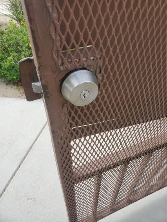 Deadbolt installed on a metal security mesh gate