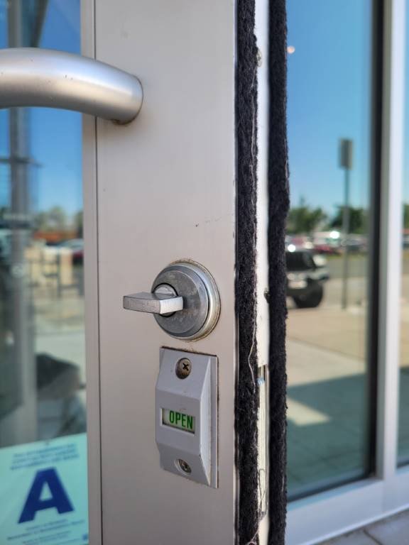Storefront lock with open and closed indicator installed