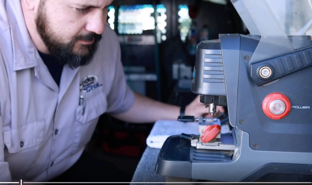Steven, automotive key specialist at Locks Around the Clock, cutting a car key on the mobile van